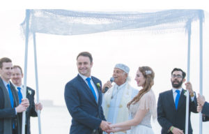 wedding service outdoors with rabbi